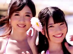A group of charming Japanese chicks share a boner on a beach tube porn video