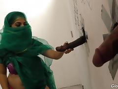 Muslim bitch sucking cocks at a gloryhole and receives a facial tube porn video