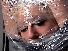Pretty girl wrapped in plastic tube porn video