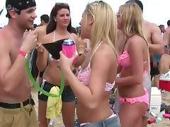 Amateur cuties wearing bikinis get caught on a voyeur's cam on a beach tube porn video